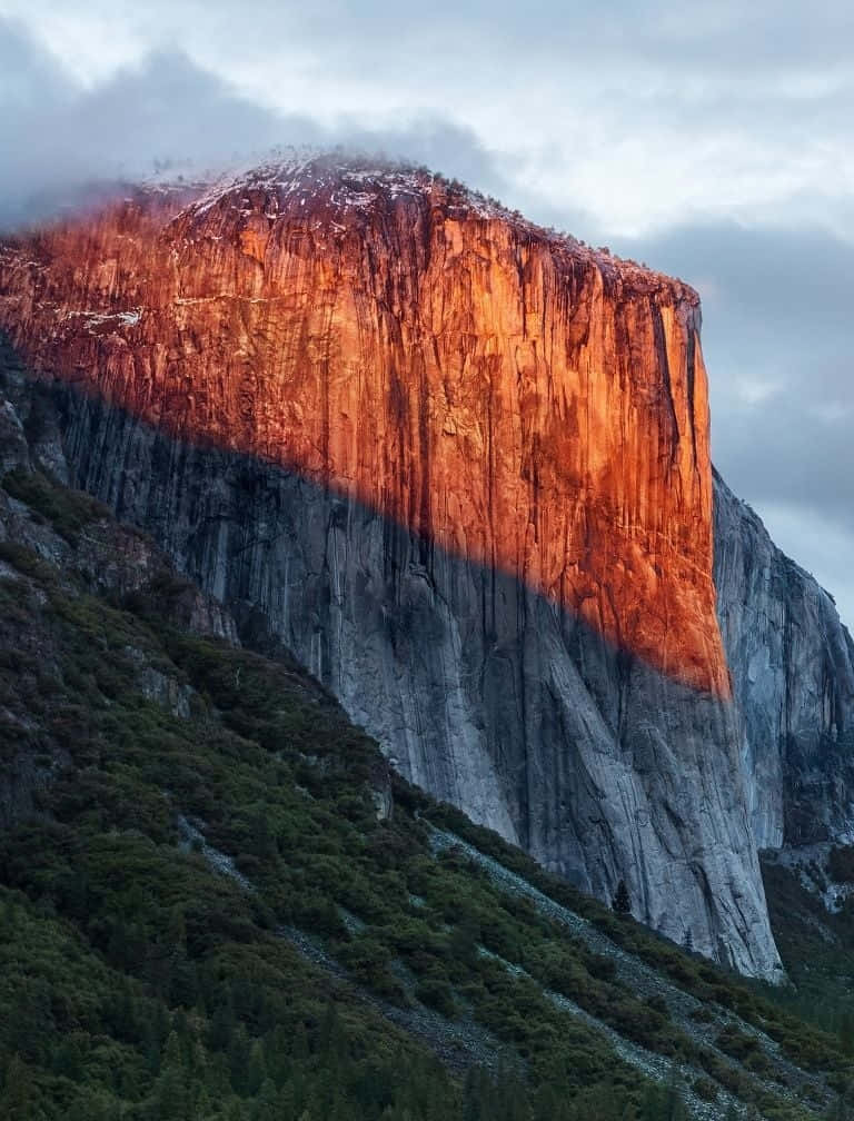 En bjerg med en rød lys skinner på det. Wallpaper