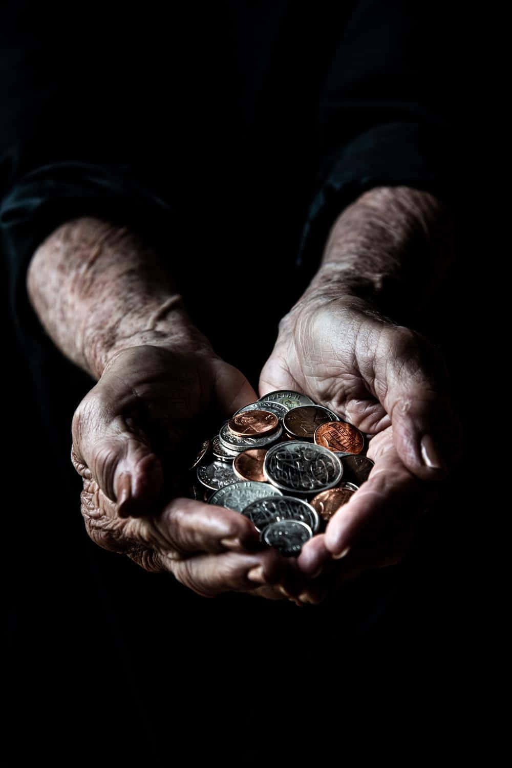 Elderly Hands Holding Coins Dark Background Wallpaper