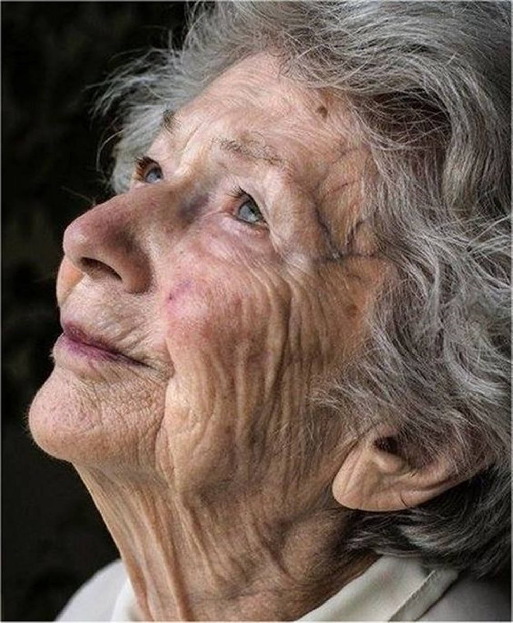 Elderly Woman Looking Up Wallpaper