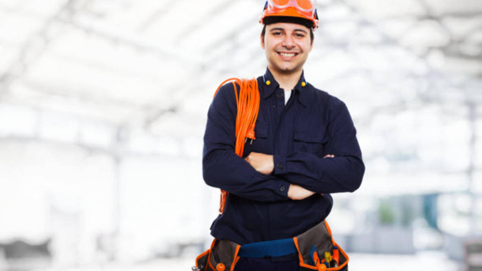 Professional Electrician Smiling at Work Wallpaper