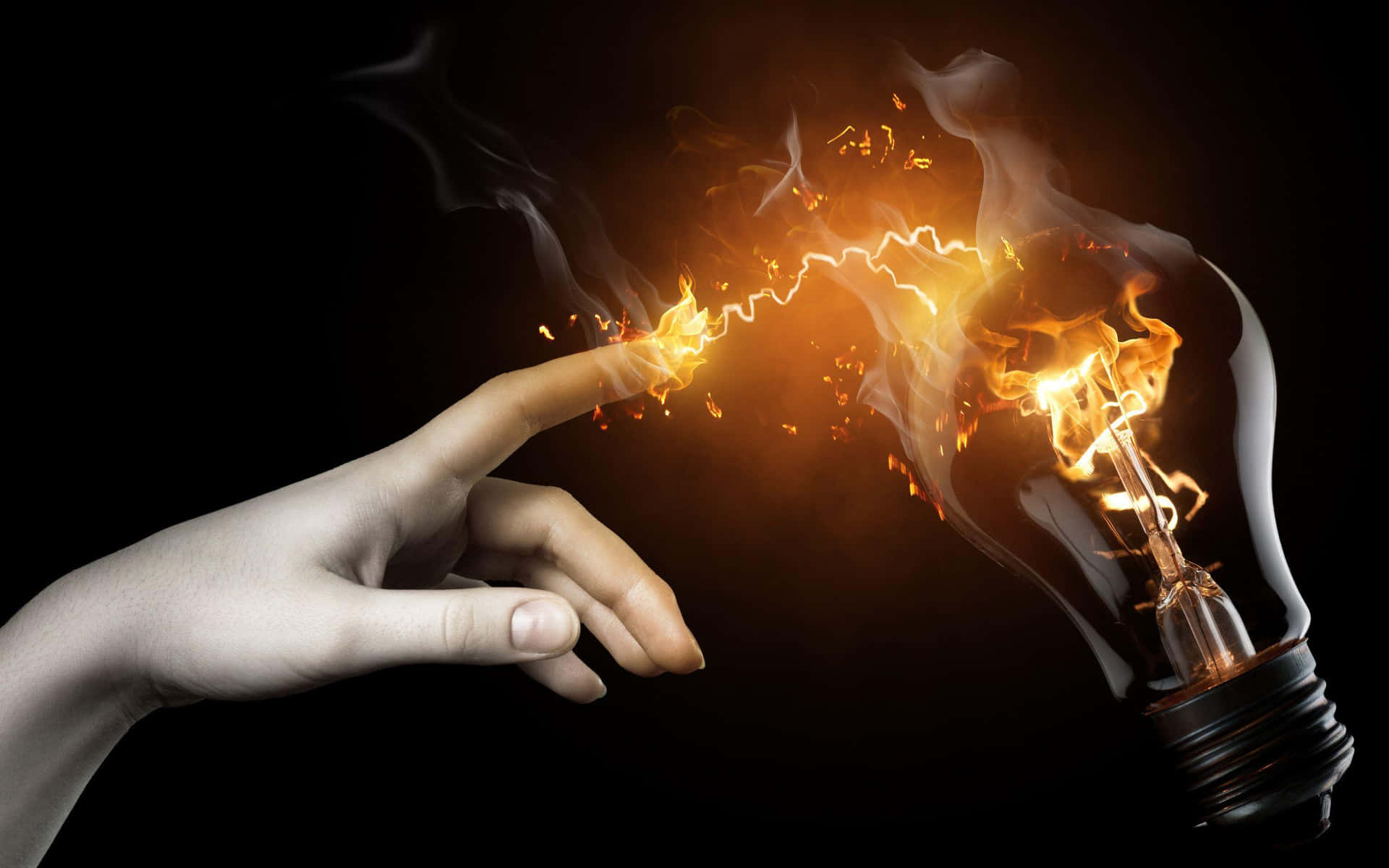 A Hand Is Touching A Light Bulb With Fire Coming Out Of It