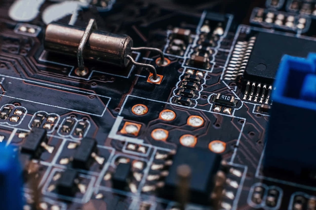 A variety of electronic components on a green circuit board Wallpaper