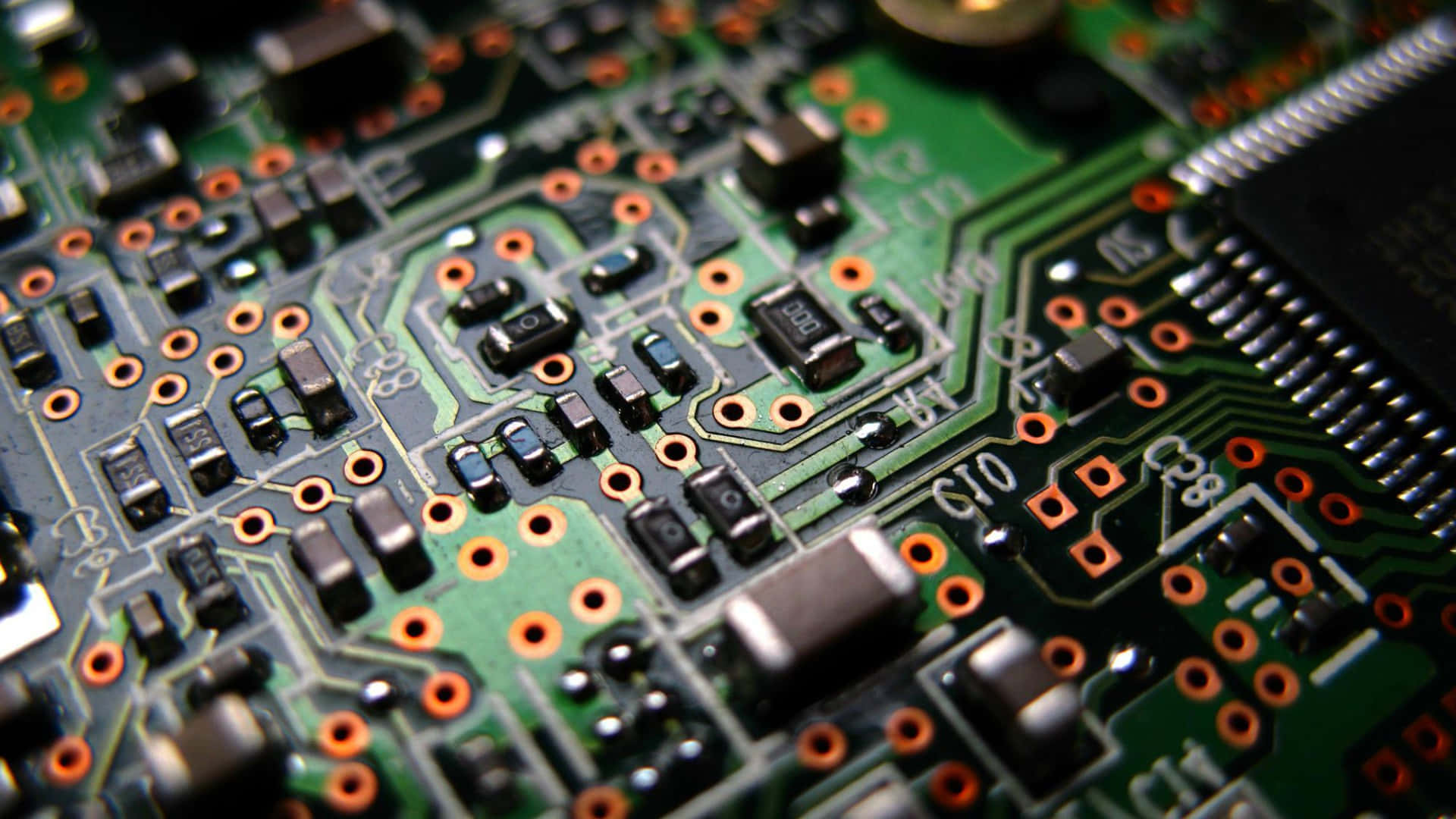 Assortment of Electronic Components on a Circuit Board Wallpaper