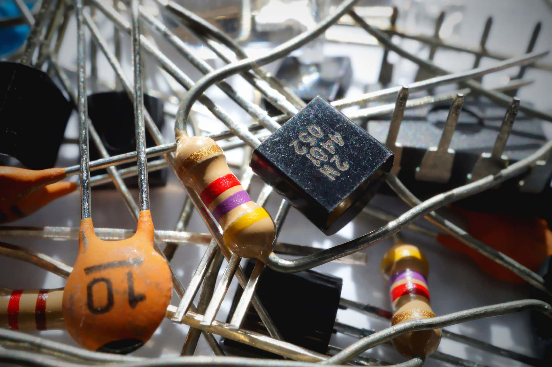 Various electronic components displayed on a table Wallpaper