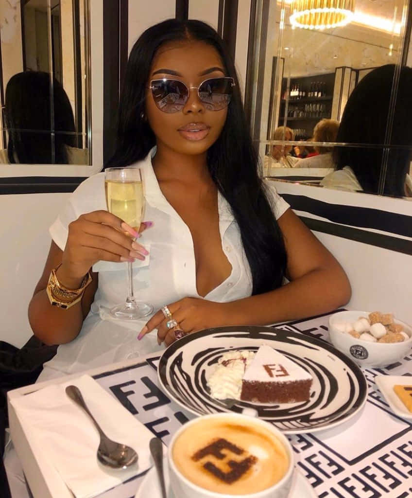 Elegant Black Woman Enjoying Luxury Dining Wallpaper