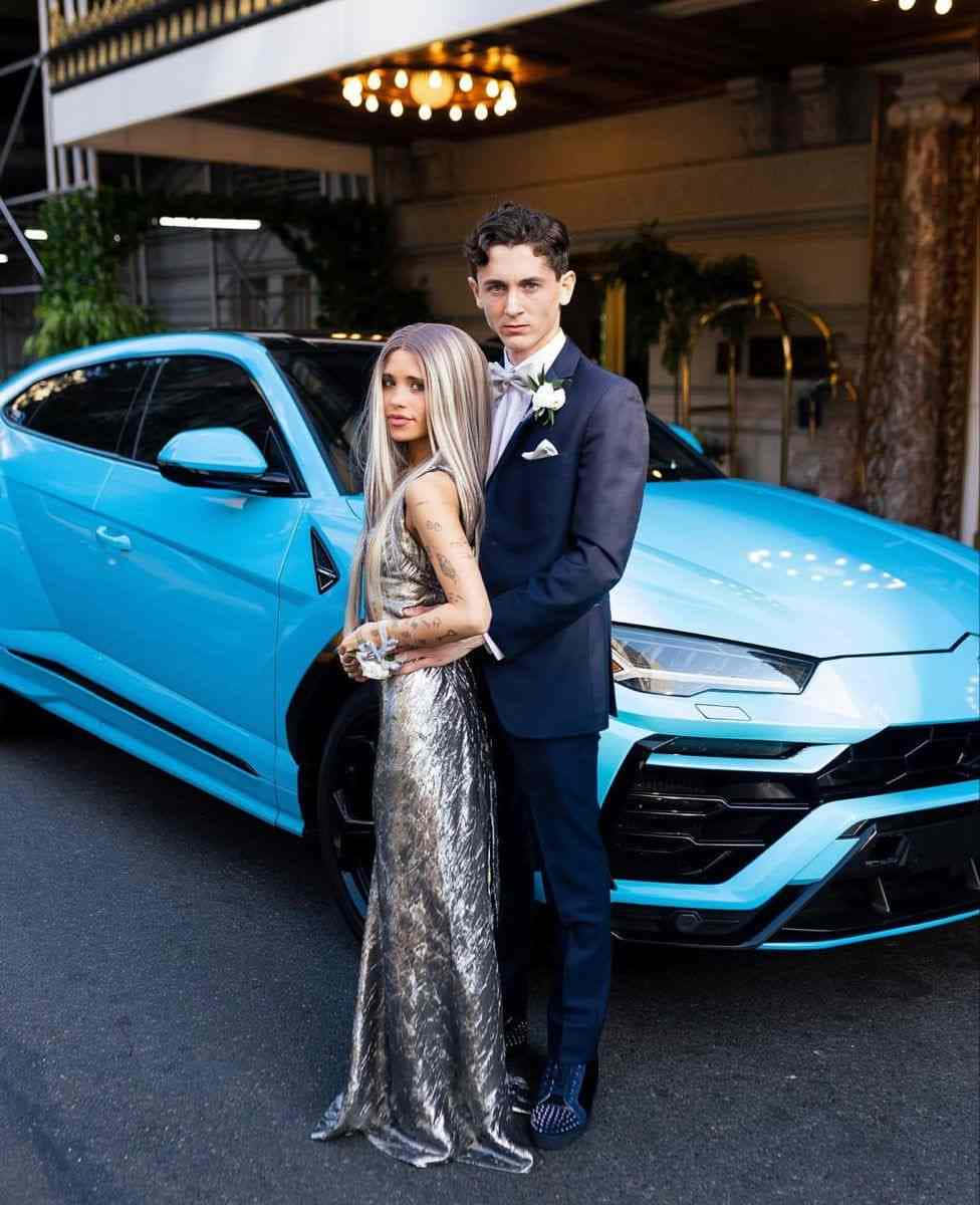 Elegant Couple Blue Sports Car Wallpaper