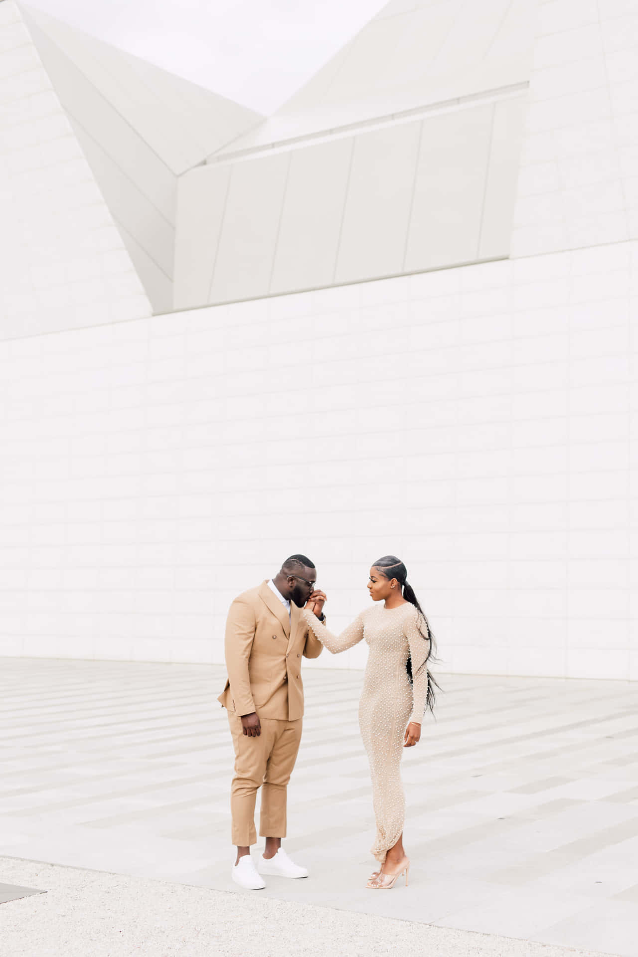 Elegant Couple Outside Modern Architecture Wallpaper