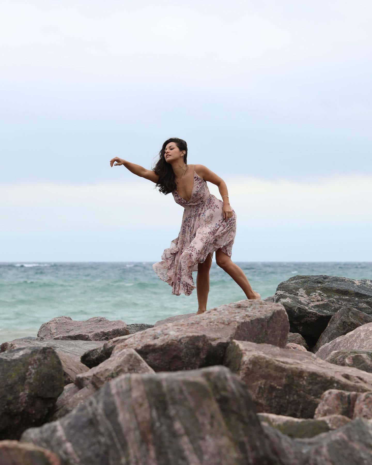 Elegant Dance Moveson Rocky Beach Wallpaper