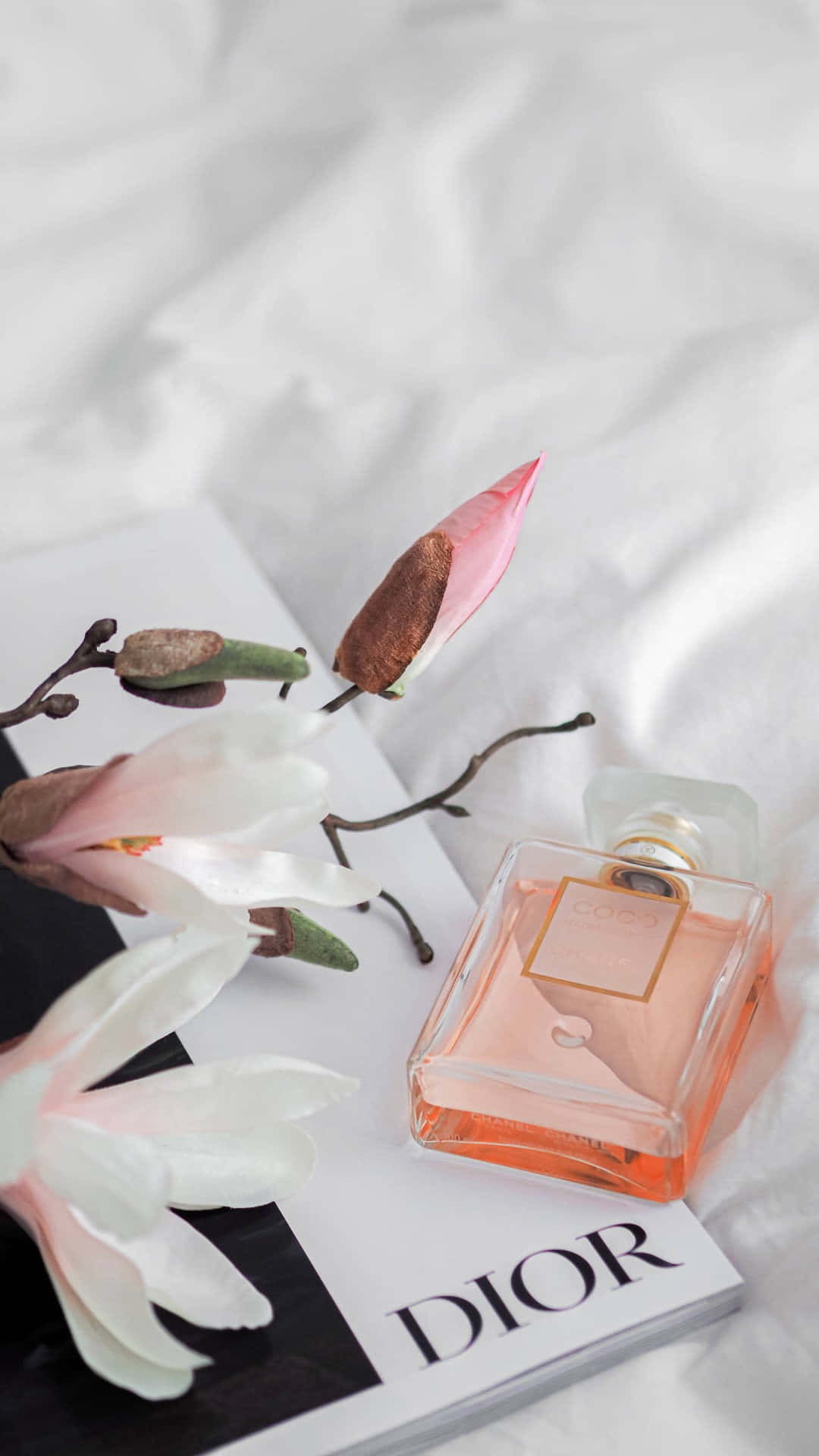 Elegant Dior Perfume Bottle Floral Arrangement Wallpaper