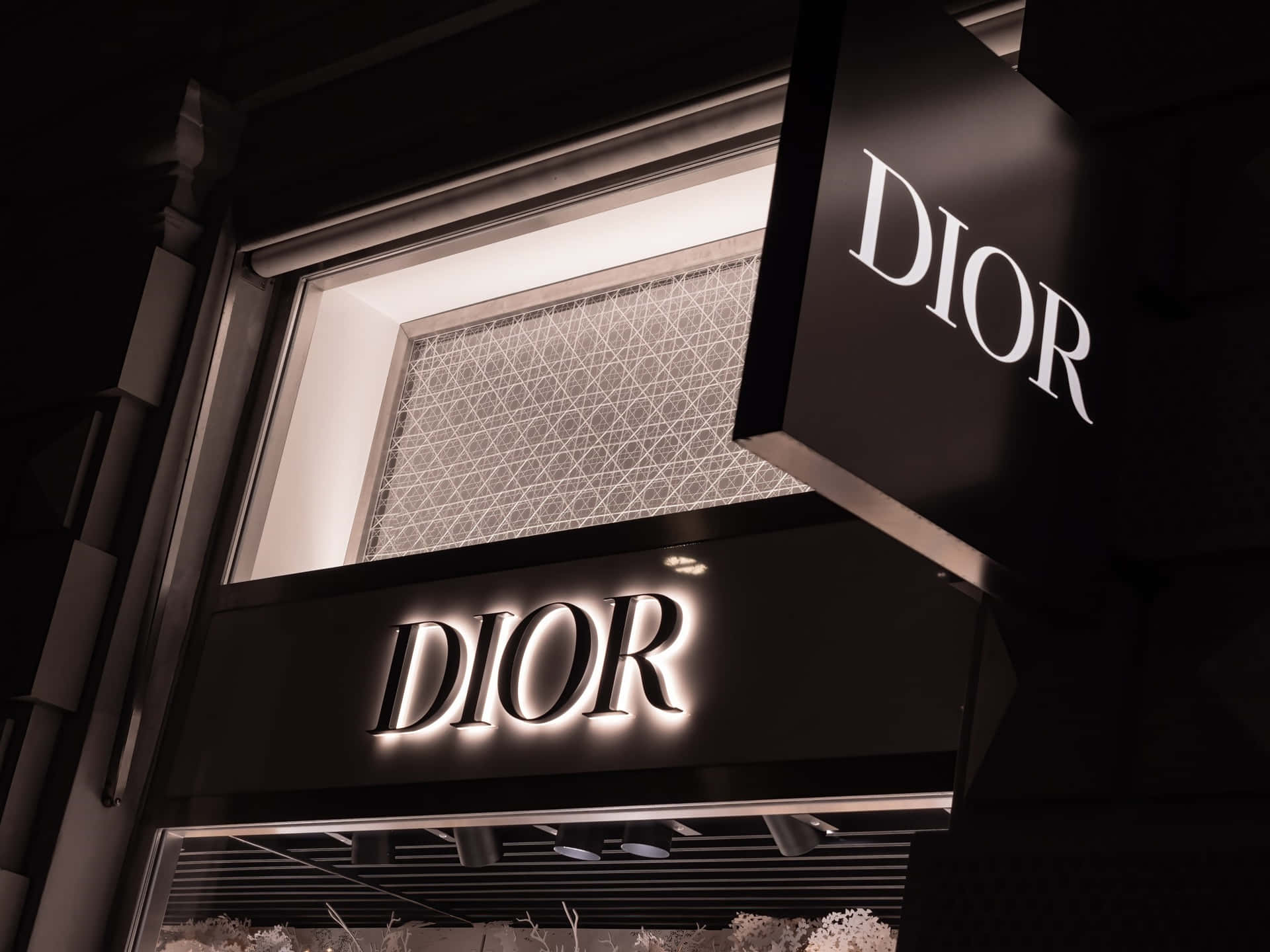 Elegant Dior Storefrontat Night Wallpaper