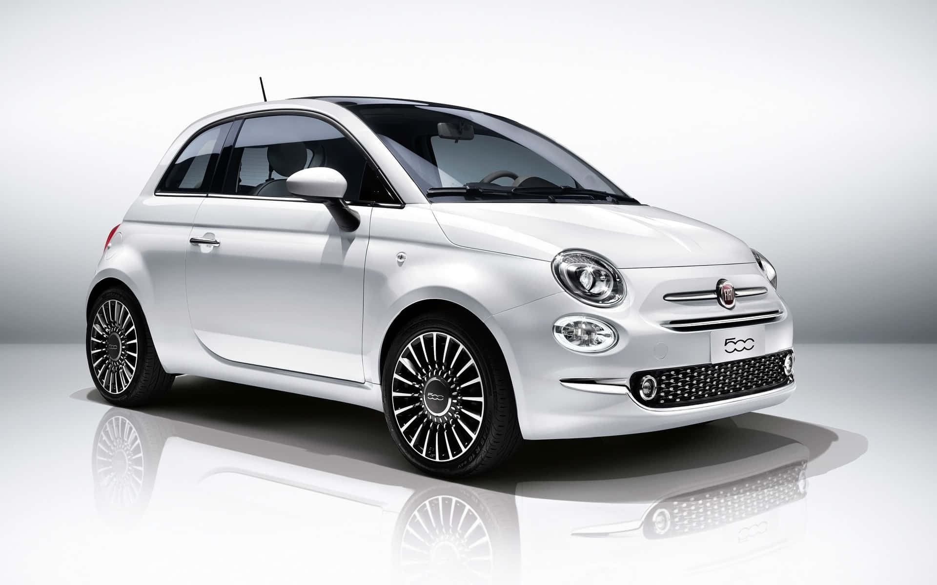 Elegant Fiat Cinquecento In Natural Urban Setting Wallpaper