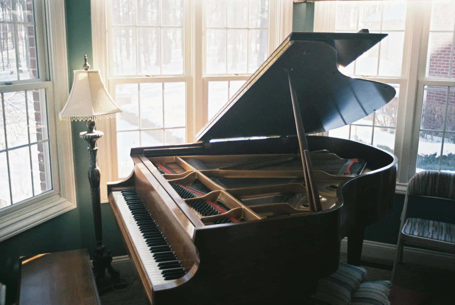 Elegant Grand Pianoin Sunlit Room Wallpaper