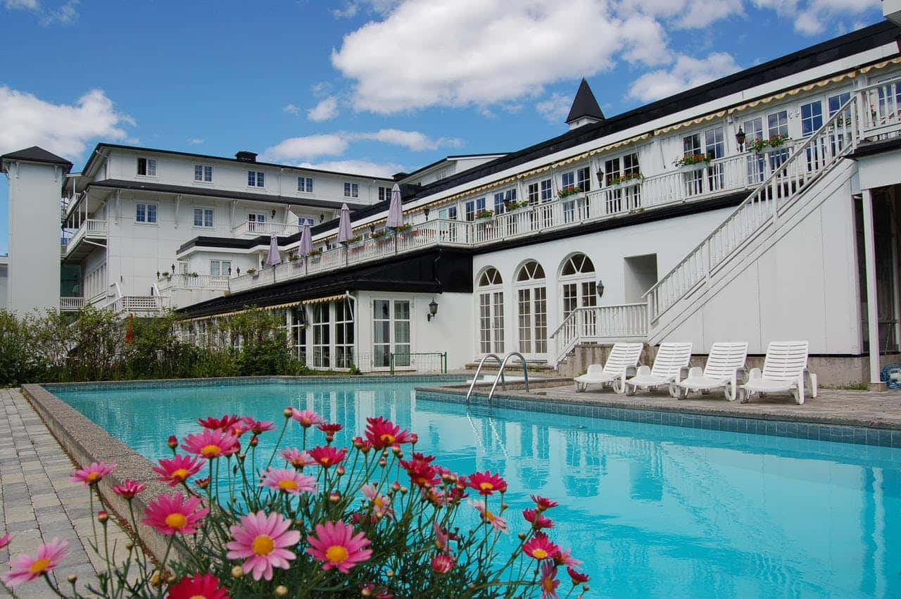 Elegant Hotelwith Poolside Lounge Area Wallpaper