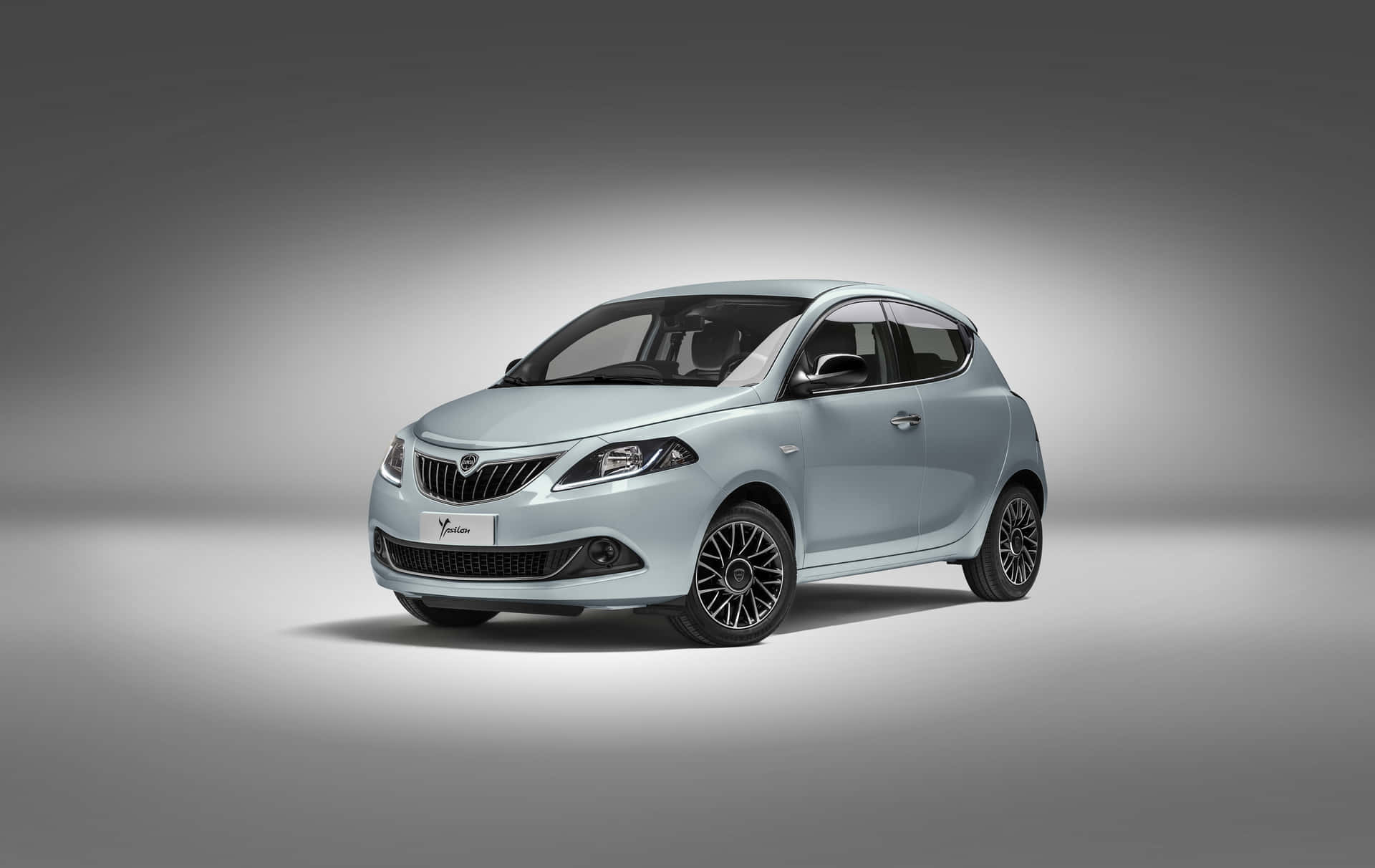 Elegant Lancia Ypsilon In Motion Wallpaper