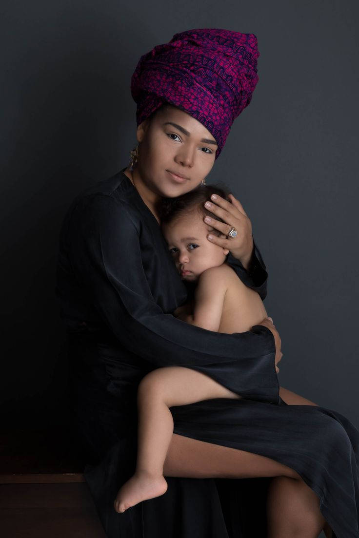 Elegant Mother And Baby Studio Shoot Wallpaper