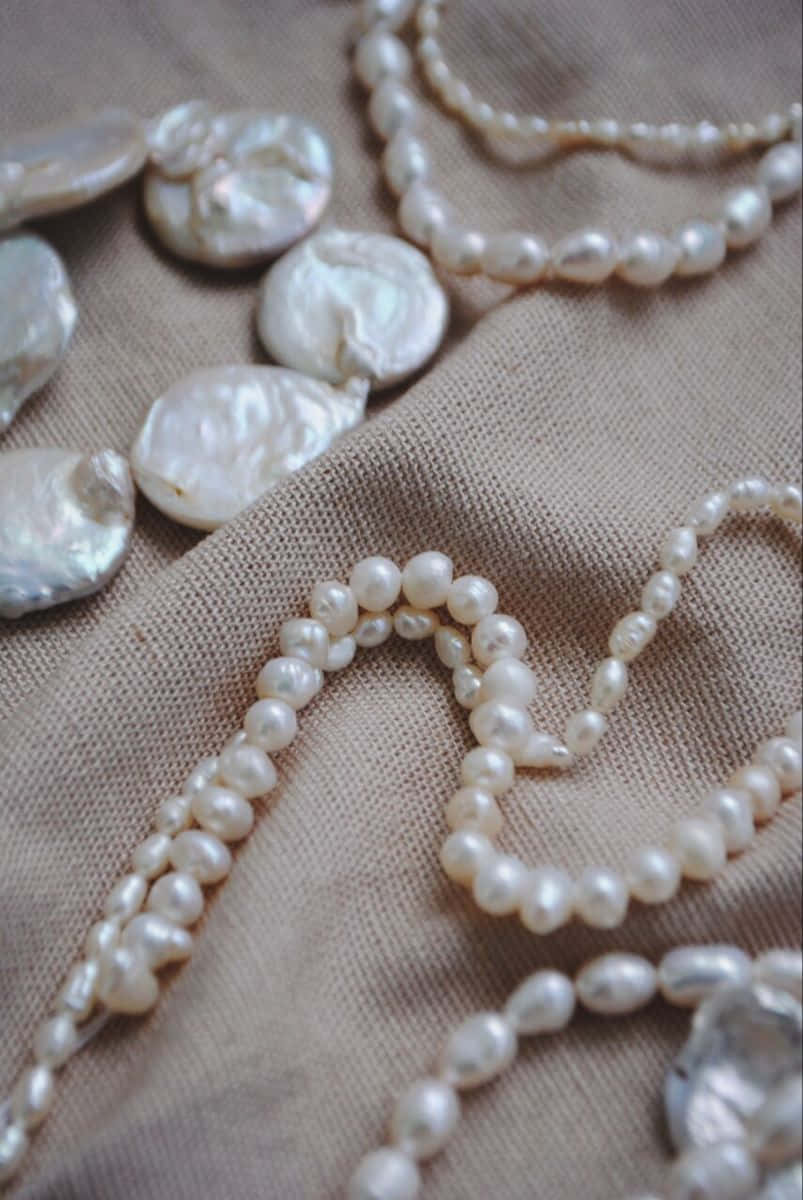 Elegant Pearl Necklaceand Loose Pearls Wallpaper