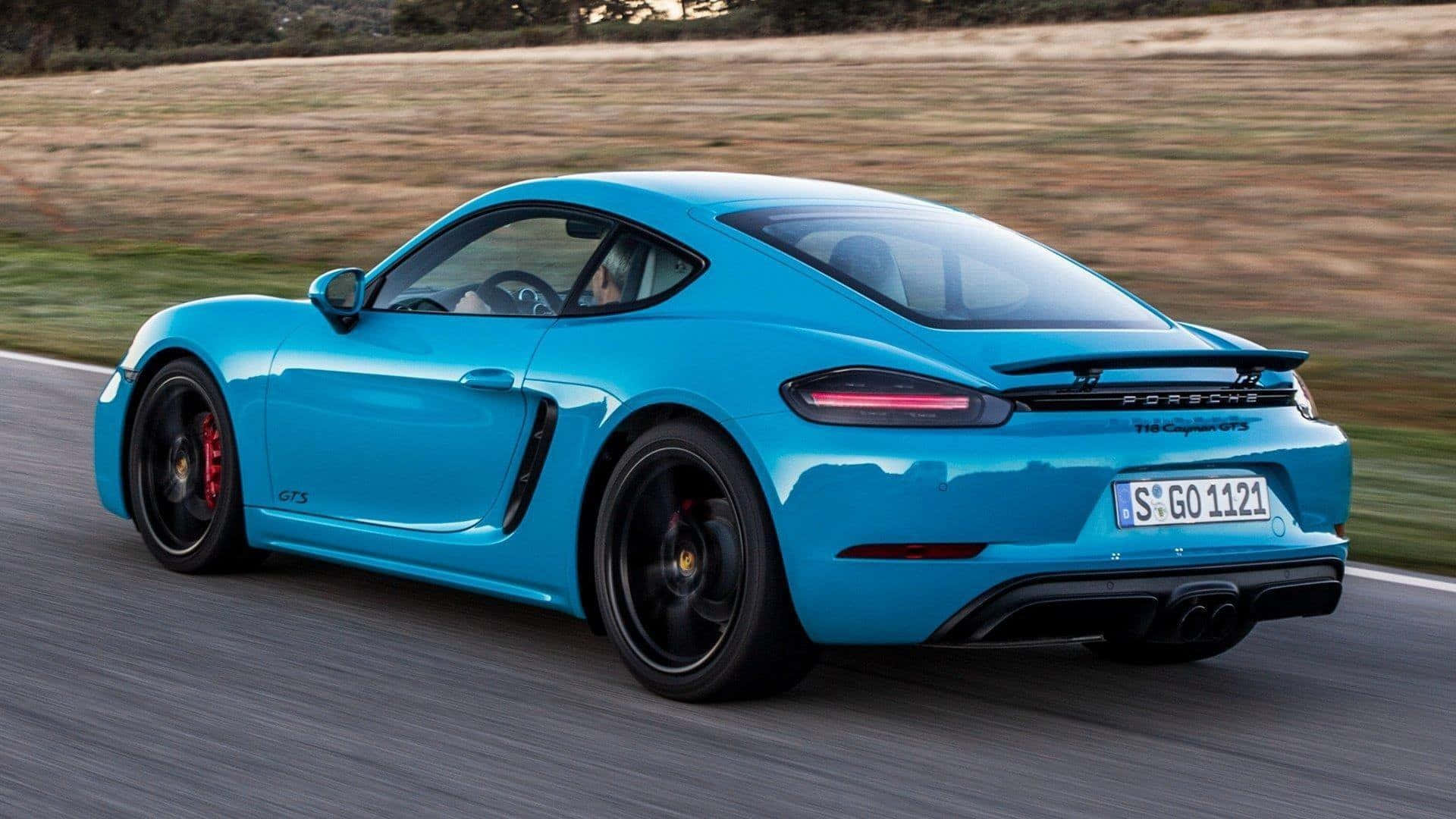 Elegant Porsche 718 Cayman On The Road Wallpaper