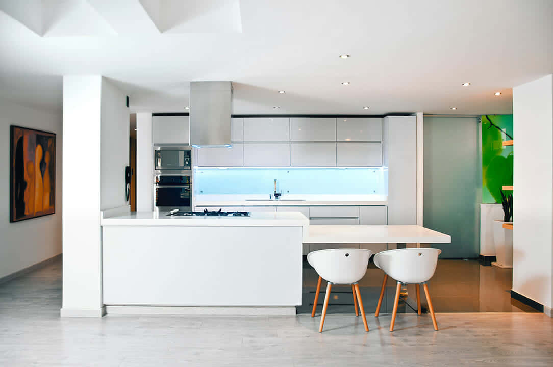 A White Kitchen With A Bar Stools