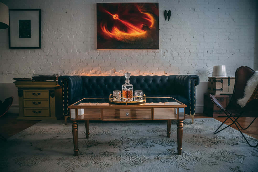 A Living Room With A Couch, Coffee Table And A Painting