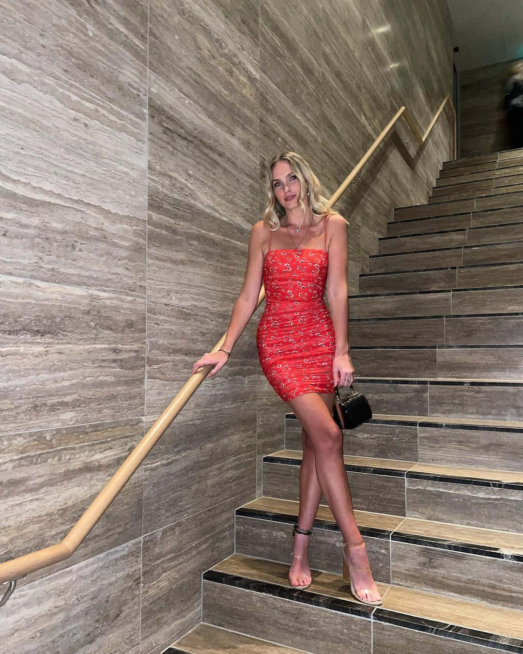 Elegant Red Dress Staircase Pose Wallpaper