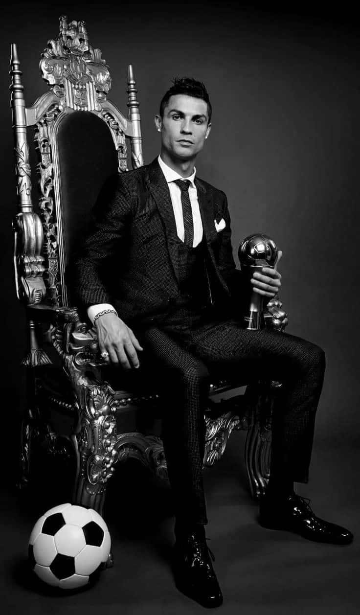 Elegant Soccer Star Throne Pose Wallpaper