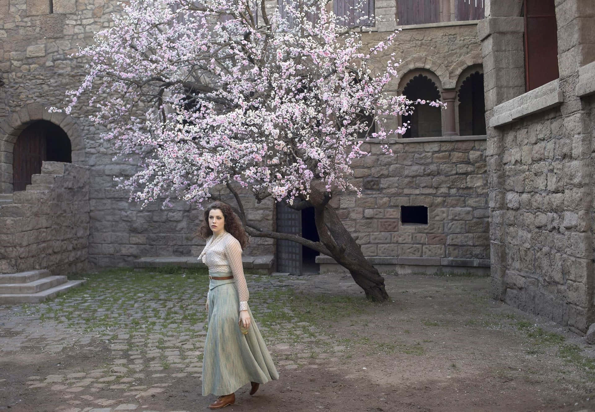 Elegant Woman Blooming Tree Courtyard Wallpaper
