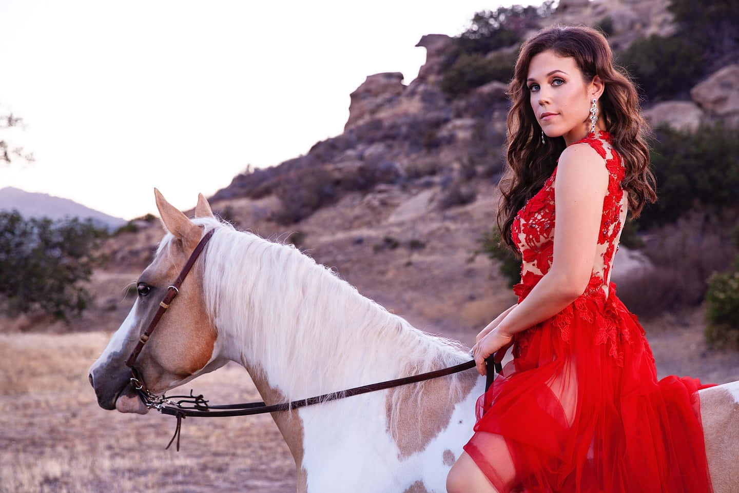 Elegant Womanin Red Dresson Horseback Wallpaper