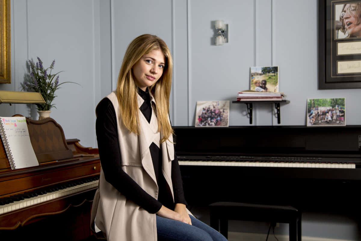 Elegant Young Woman Piano Room Wallpaper