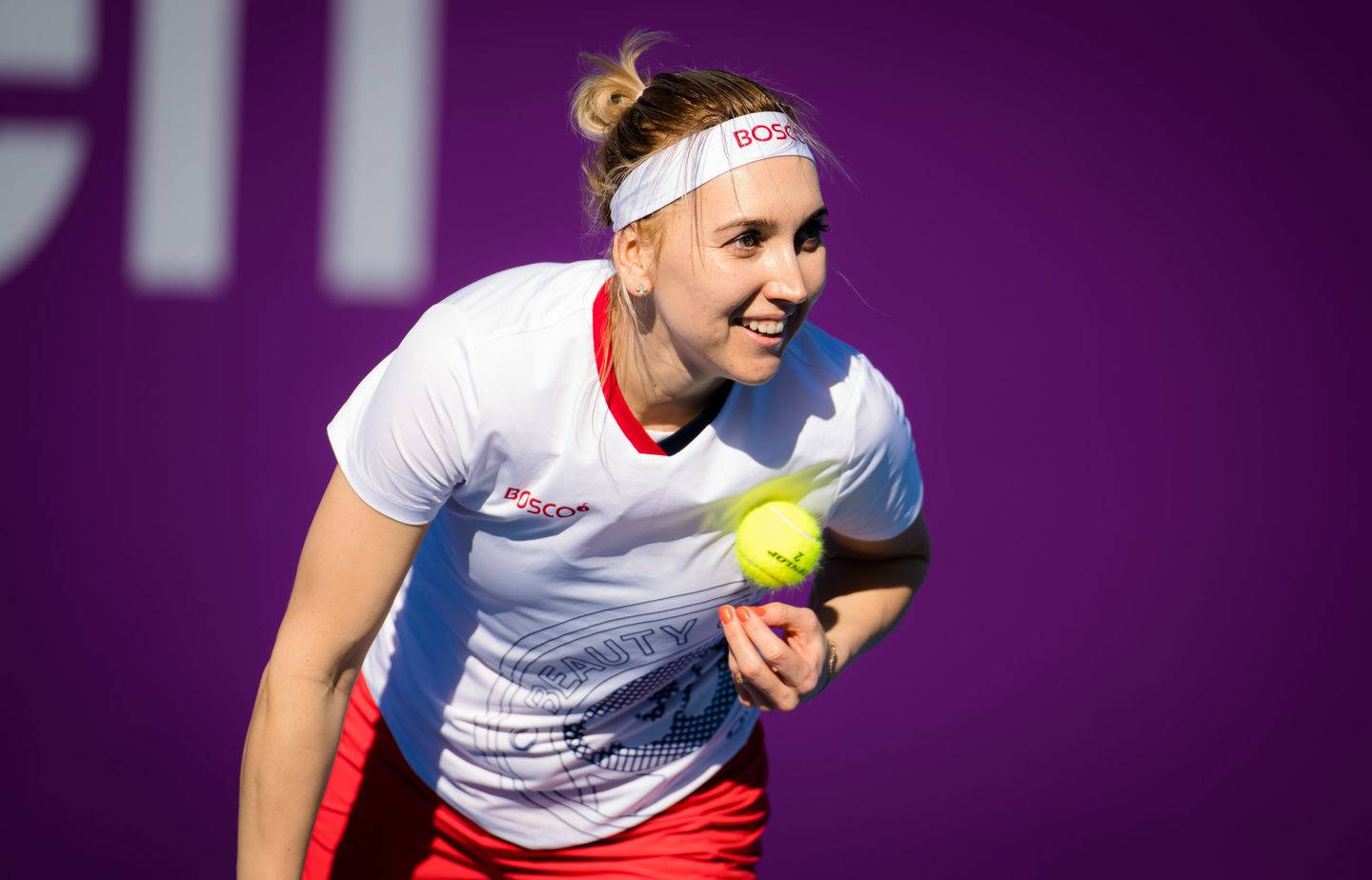 Bright Smiling Elena Vesnina Holding a Tennis Ball Wallpaper