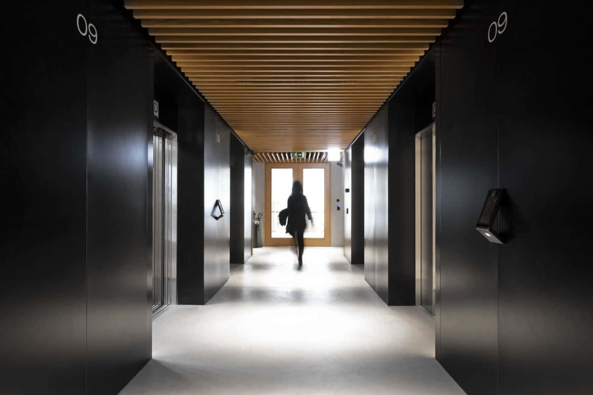 A Hallway With A Person Walking Down It