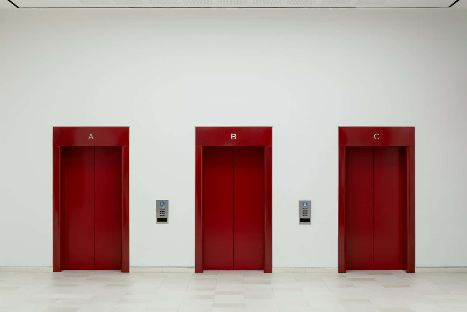 Three Red Elevators In A Room