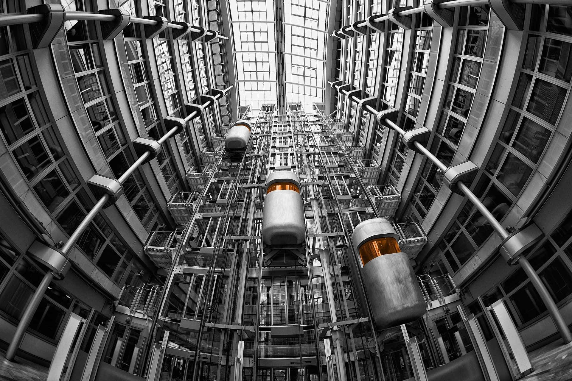 A Black And White Photo Of A Building With Many Tubes