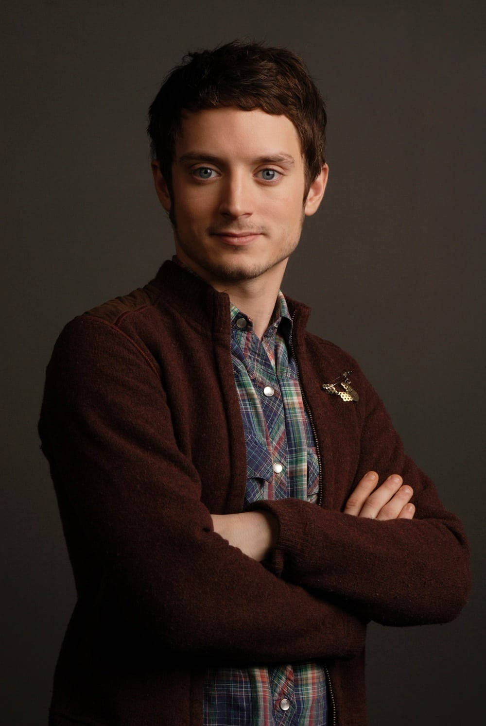 Hollywood Actor Elijah Wood Captured in a Stylish Brown Padded Jacket Wallpaper