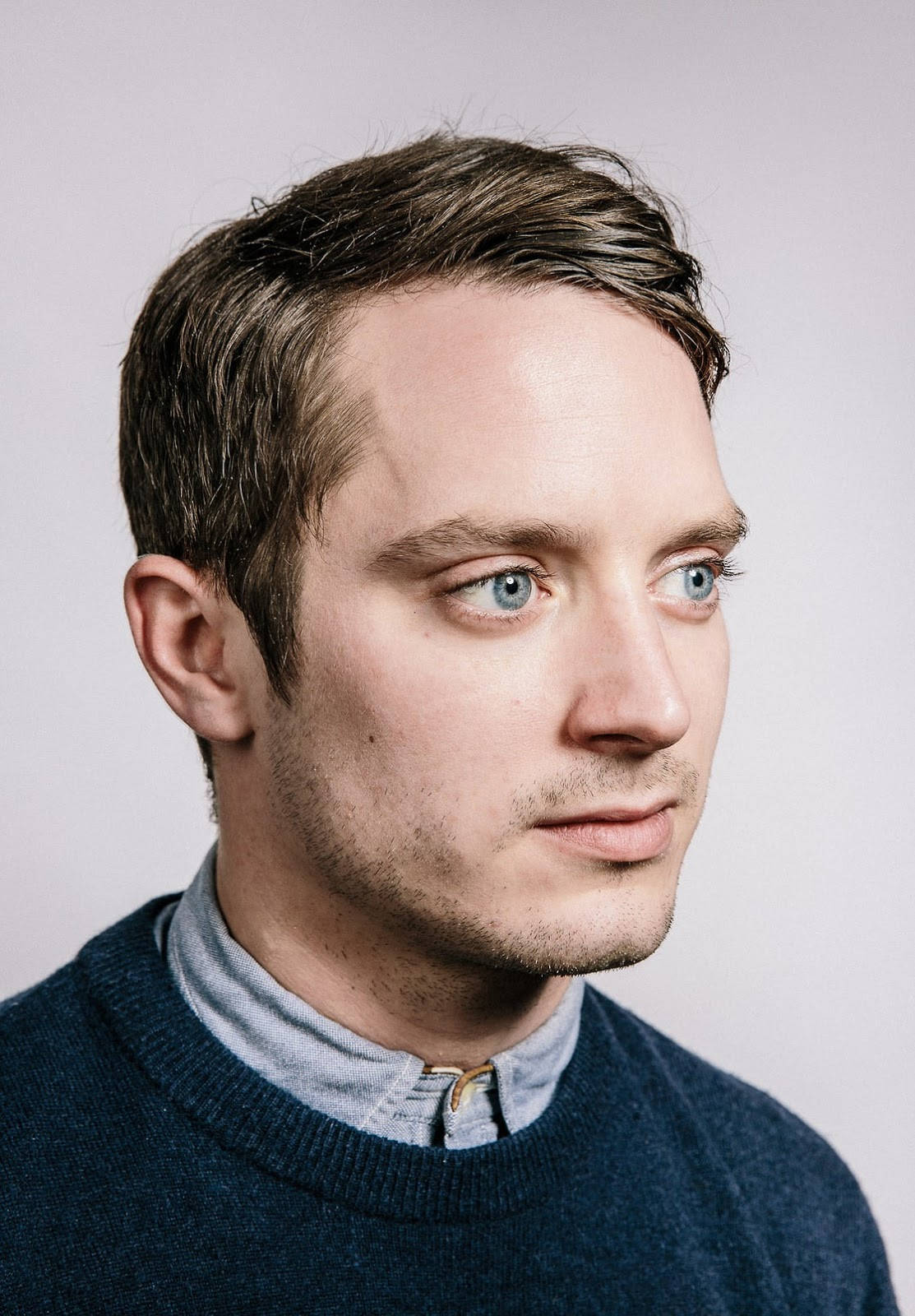 Download Elijah Wood On A White Background Wallpaper | Wallpapers.com