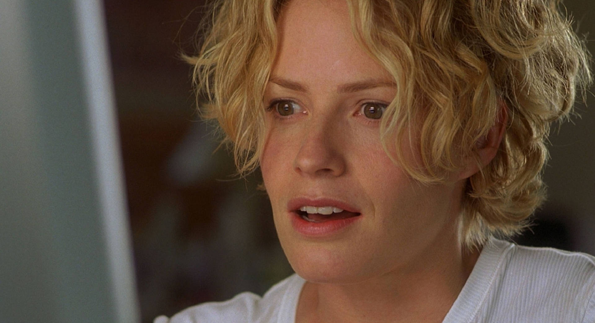 Elisabeth Shue With Short Blonde Curly Hair And Shocked Expression Wallpaper