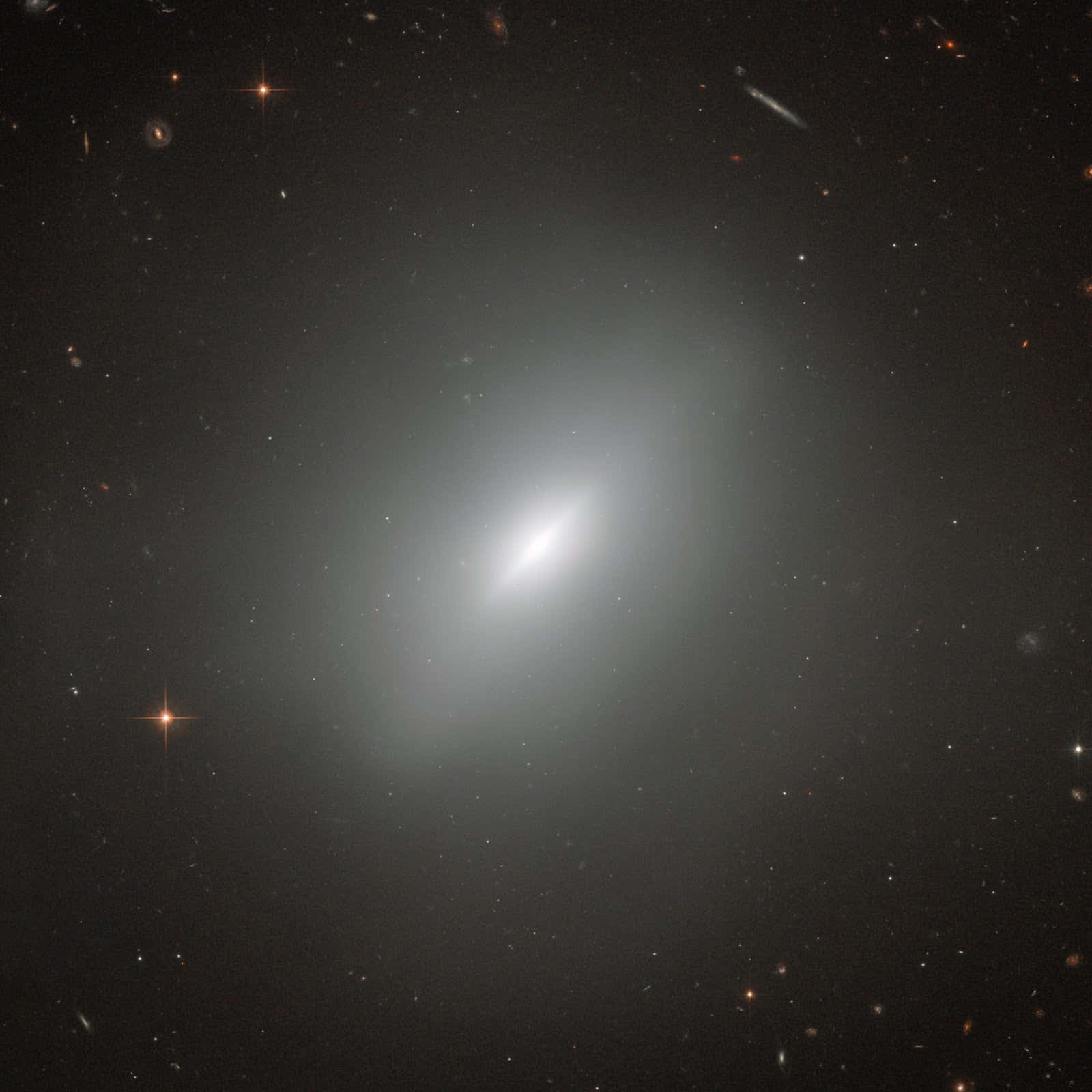 A Stunning View of an Elliptical Galaxy in the Expansive Universe Wallpaper