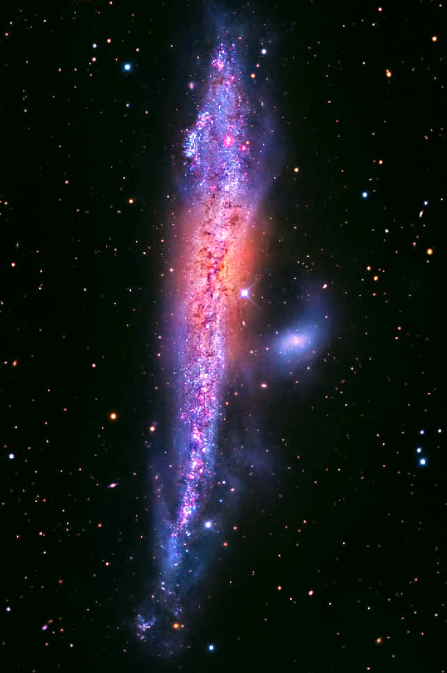 A Stunning View of an Elliptical Galaxy in Deep Space Wallpaper
