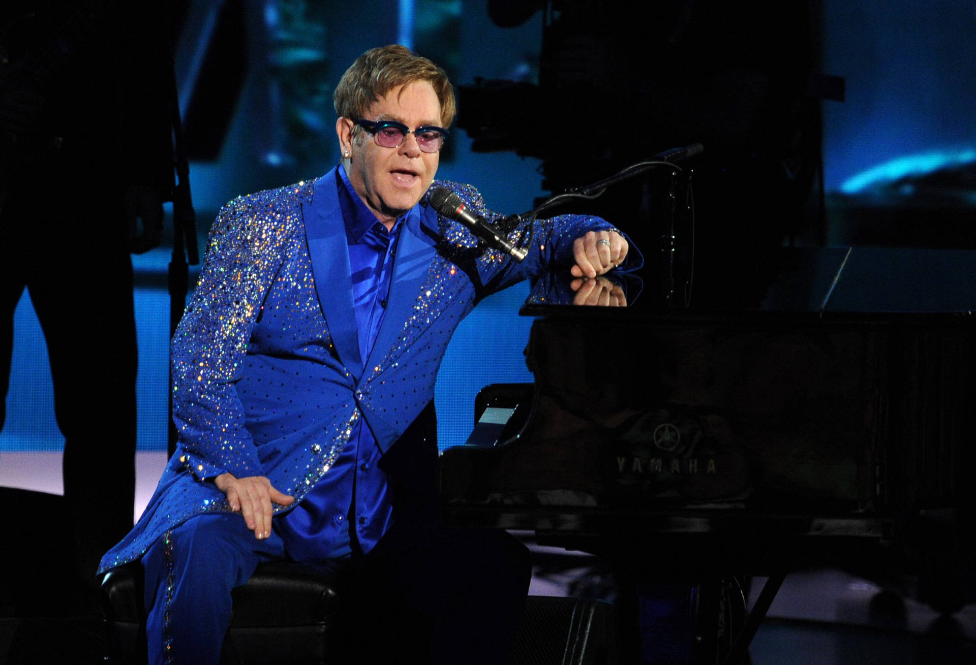 Elton John In Blue Glittered Suit Background