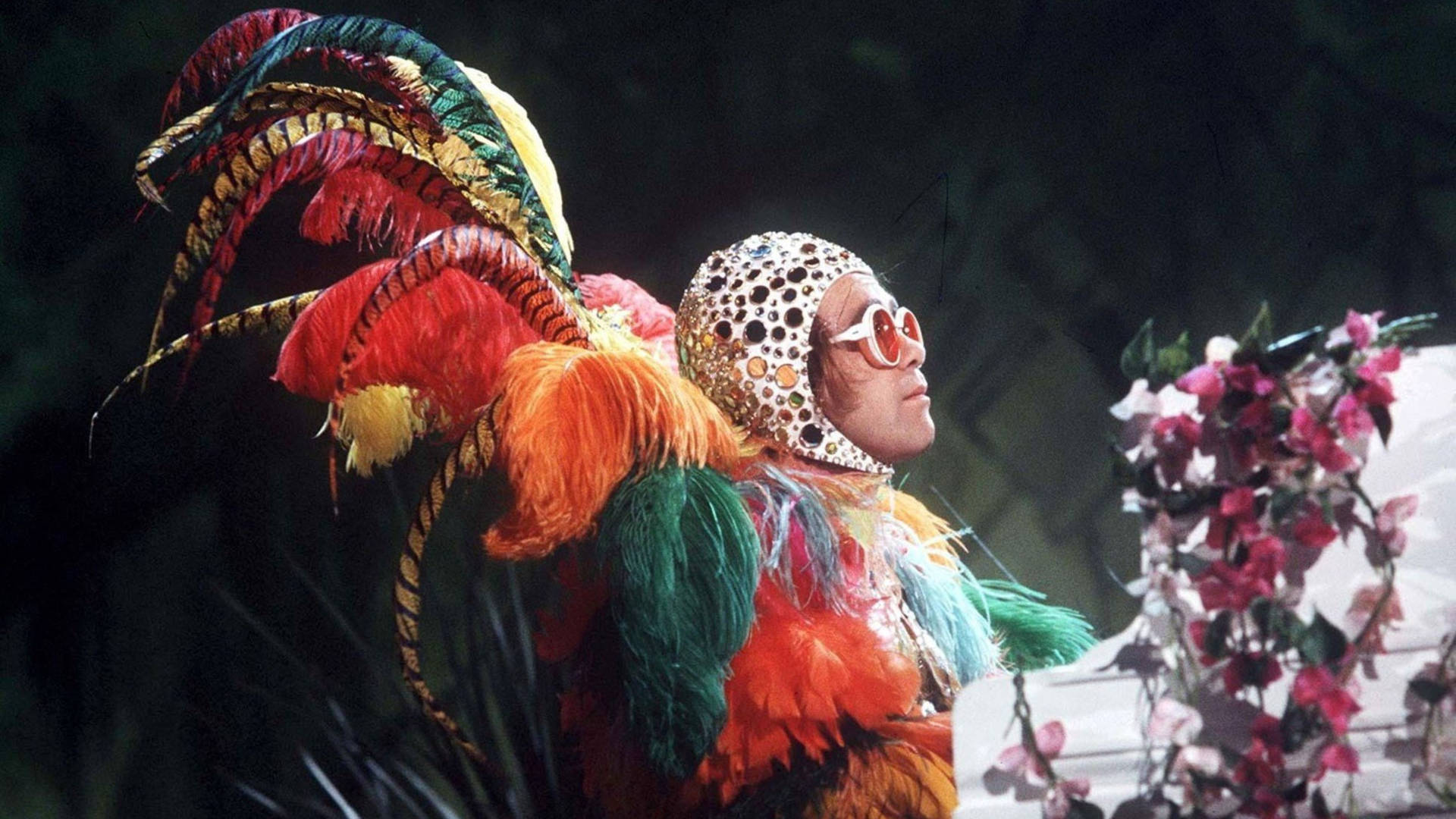 Elton John In Peacock Suit Background