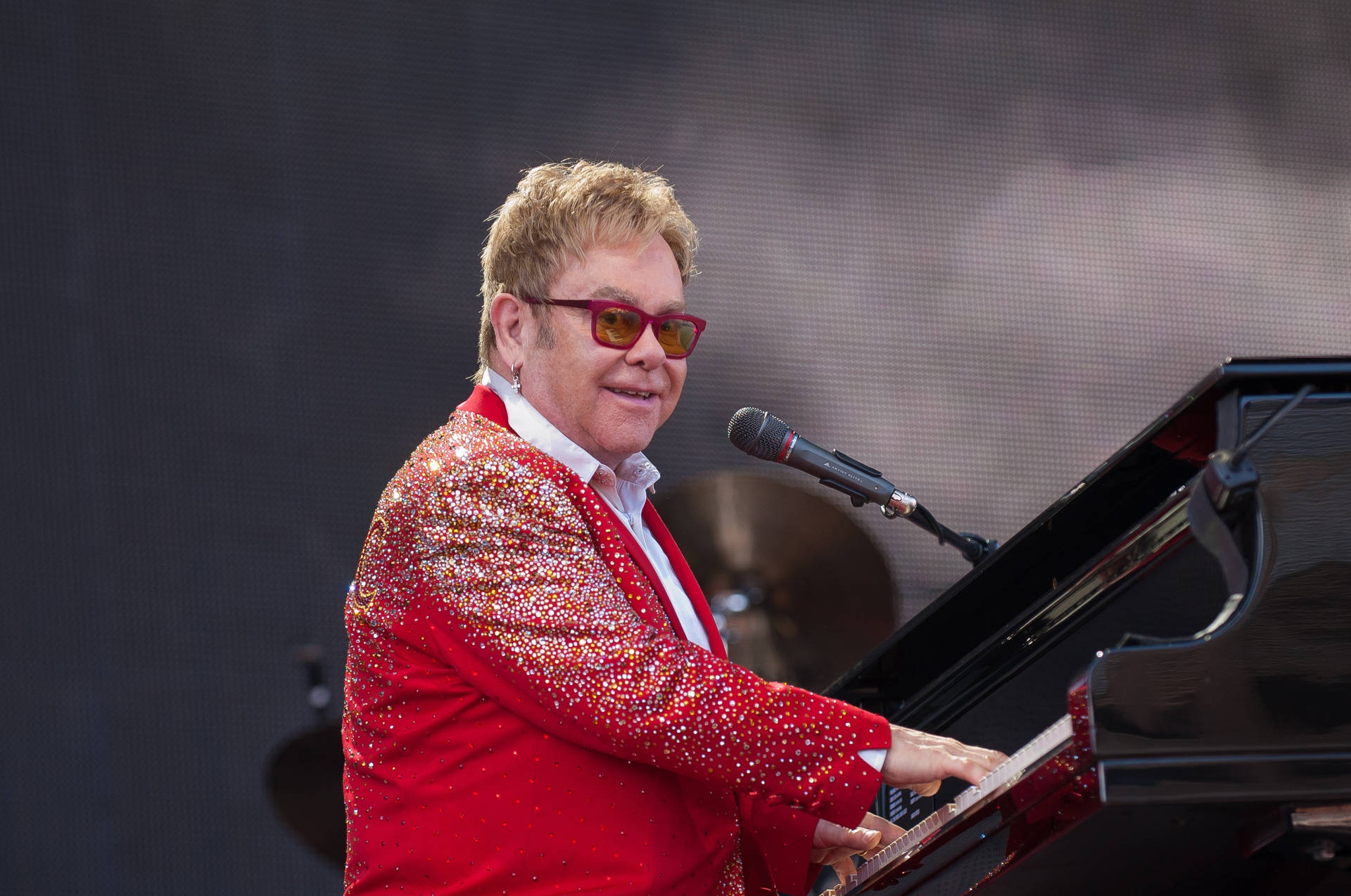 Elton John Pianist In Red Suit Background