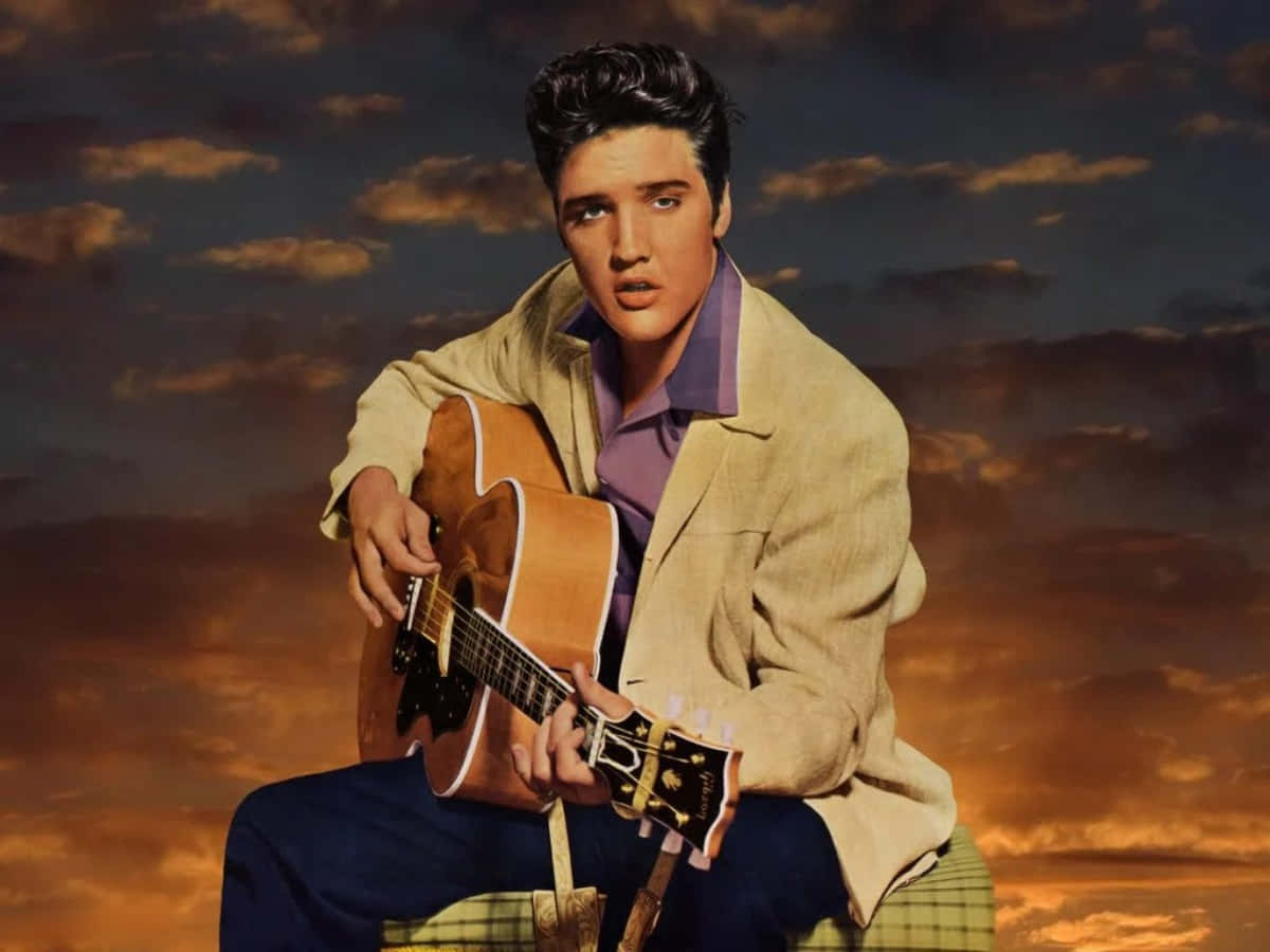 Elvis Presley Sitting On A Chair With An Acoustic Guitar