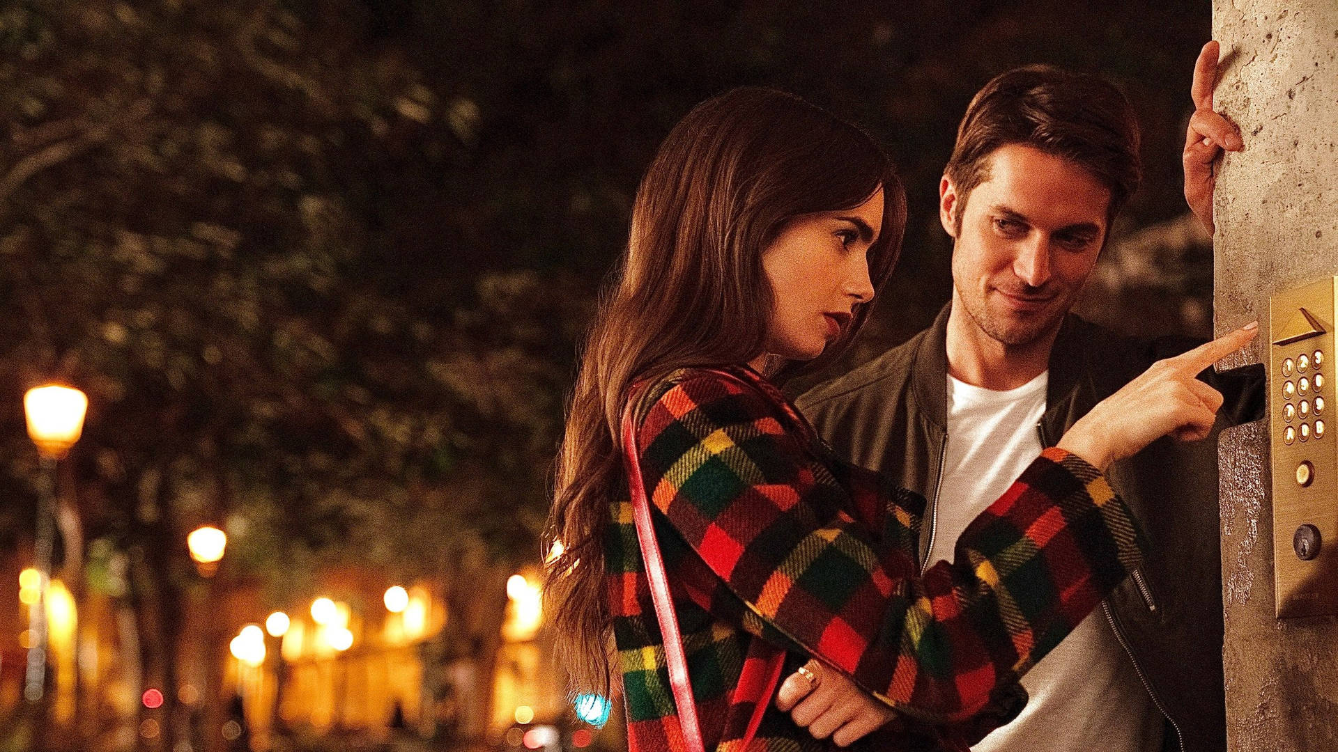 Emily, played by Lily Collins, and Gabriel, played by Lucas Bravo, enjoying a romantic moment in Paris. Wallpaper