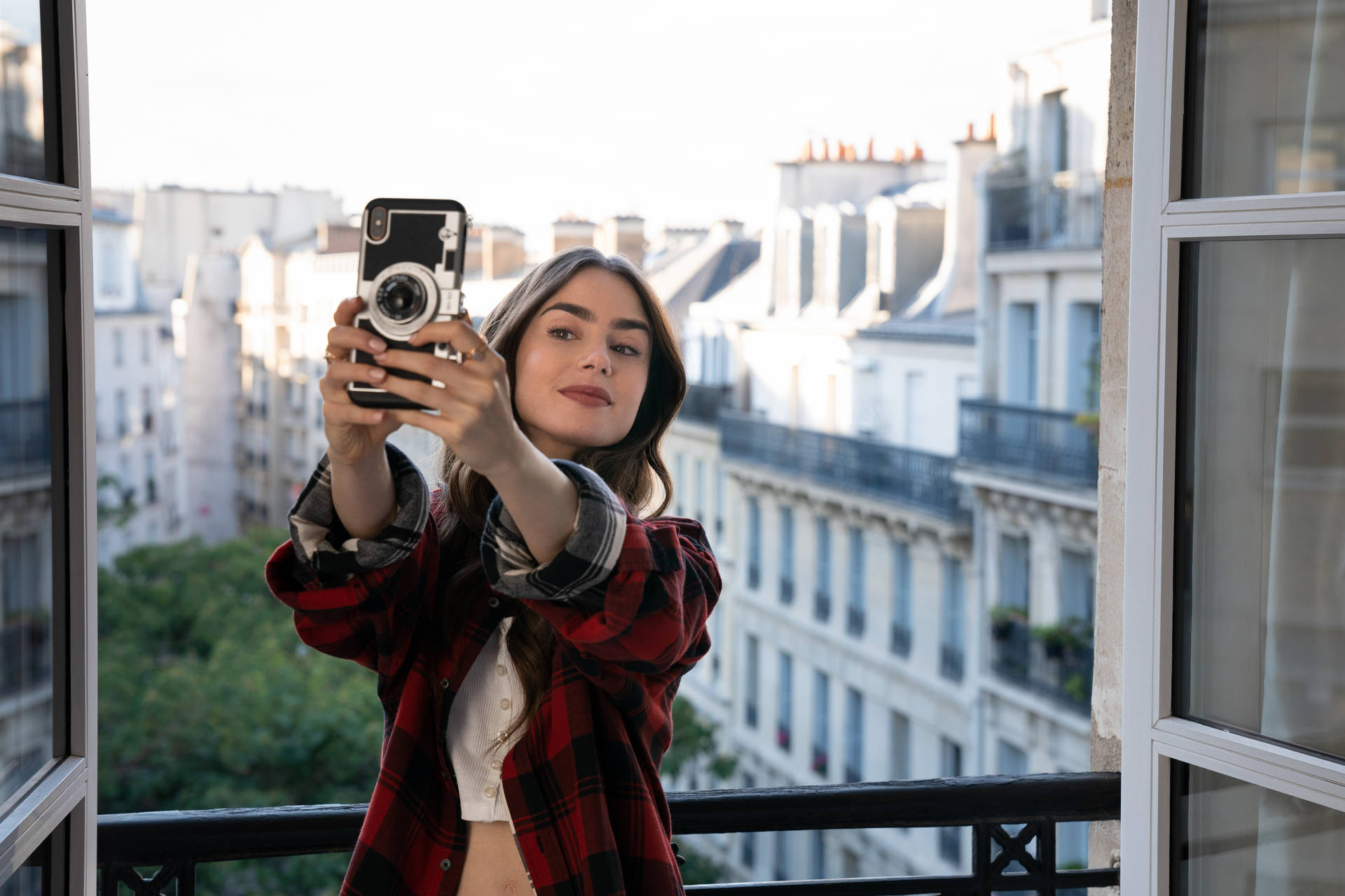 Emily in Paris capturing her vacation memories in a Selfie Wallpaper
