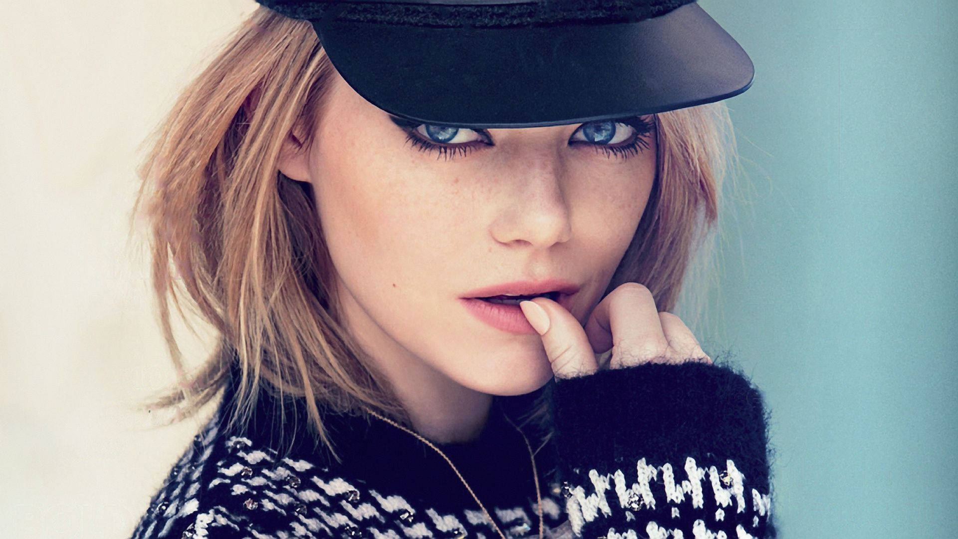 Emma Stone looking stylish in a black cap Wallpaper