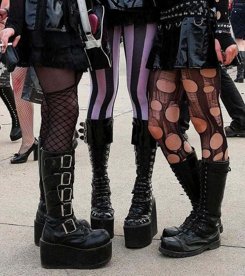 Three Women In Gothic Outfits Standing Together