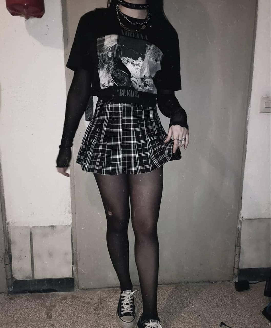 A Girl Wearing A Plaid Skirt And A T Shirt