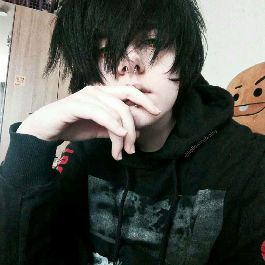 A Boy With Black Hair And A Black Hoodie