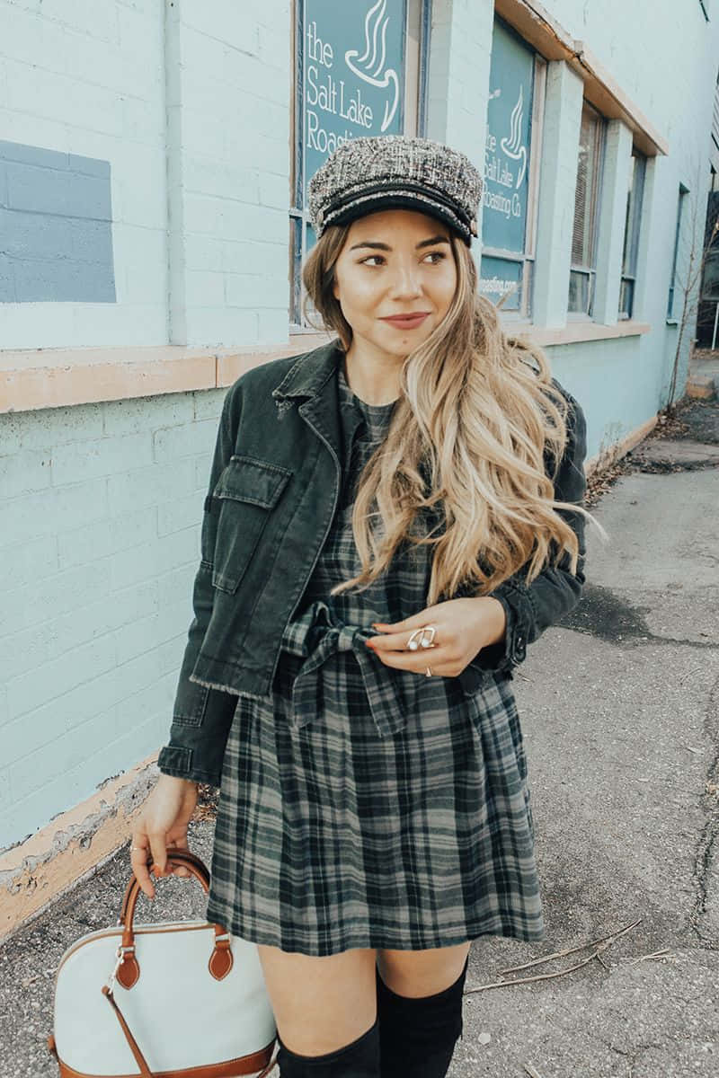 A Woman In A Plaid Dress And Over The Knee Boots