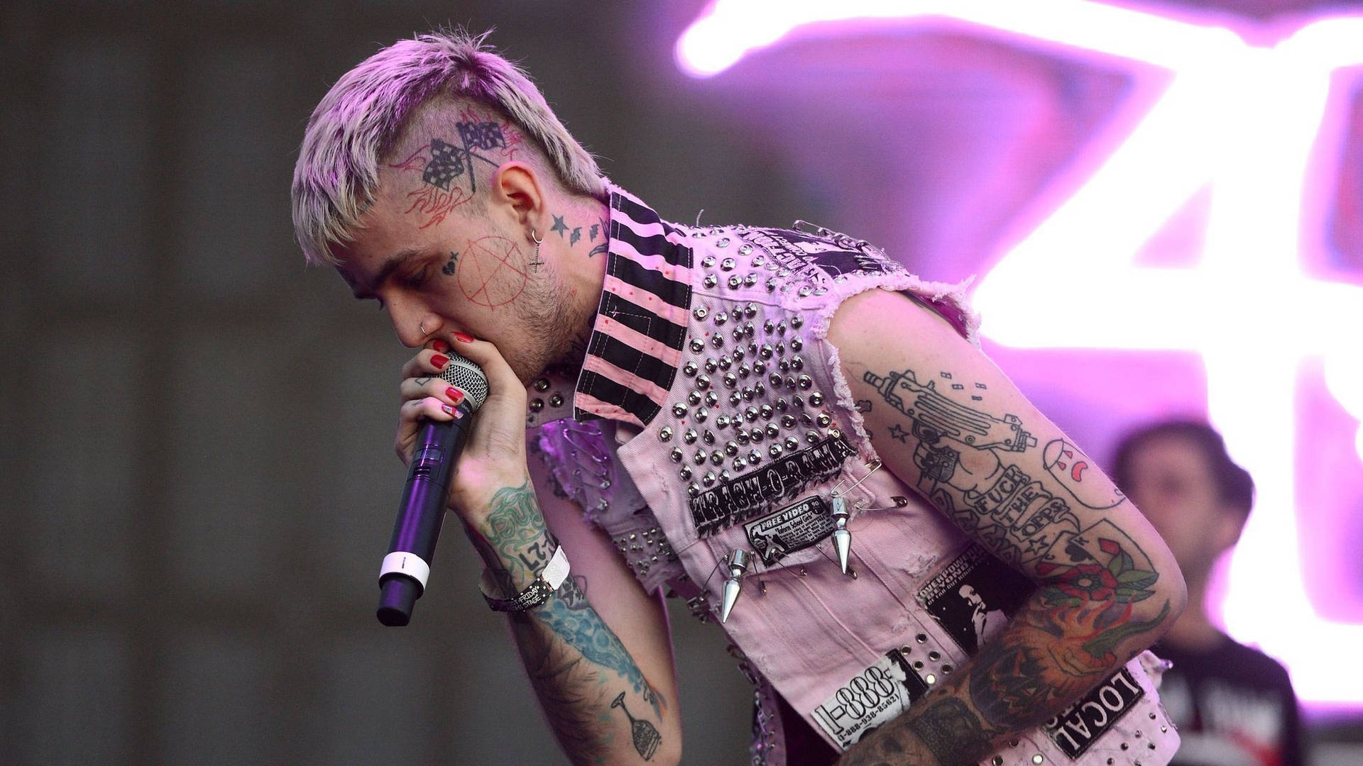 Lil Peep performing live on stage at an emo rock concert Wallpaper