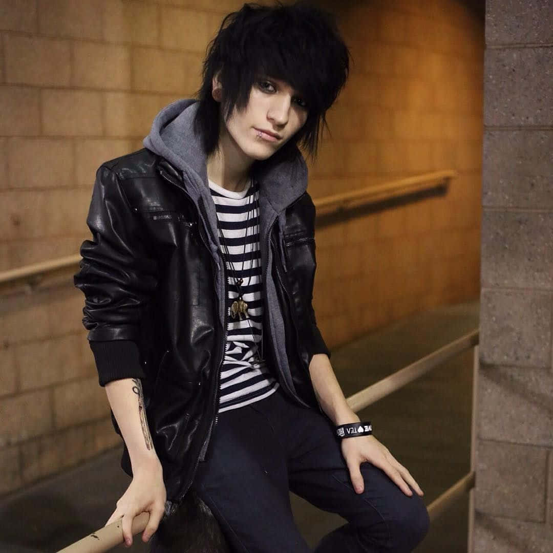 Emo Styled Youth Leaning Against Wall Wallpaper